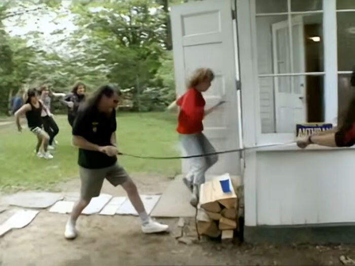 People struggling outdoors pulling a rope around a corner, illustrating unexpected PR mistakes backfiring for companies.