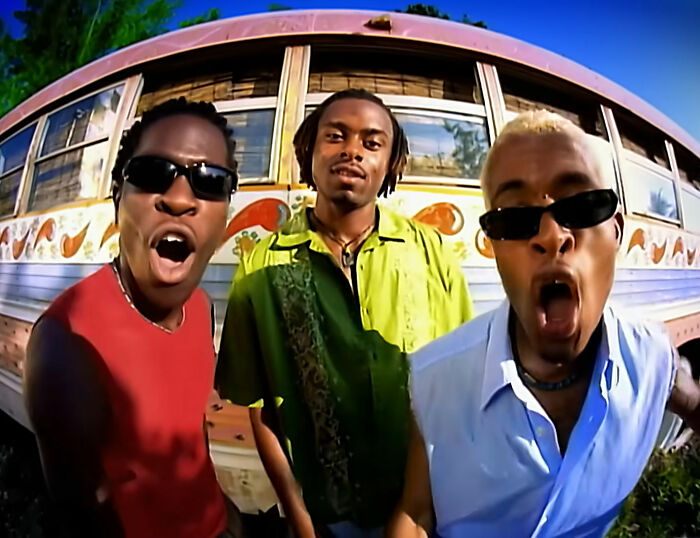Three men wearing sunglasses in front of a bus, related to creepy and mysterious things people lose sleep over.
