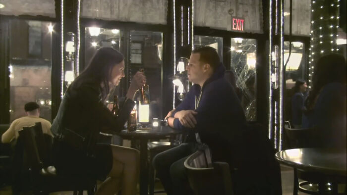 Two people talking over drinks at a dimly lit bar, illustrating PR mistakes that companies didn’t expect to backfire.