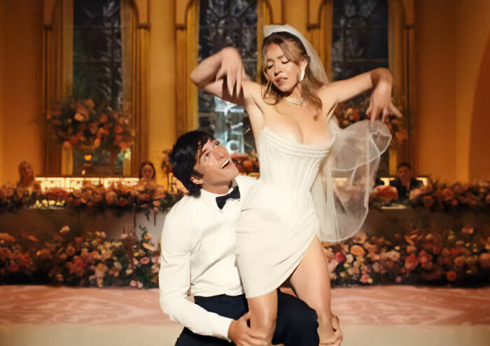 Scene from Euphoria showing Sydney Sweeney dancing in a wedding dress during a controversial episode of season 3.