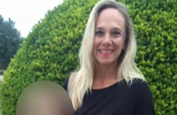 Woman with blonde hair smiling outdoors against a large green bush, related to creepy and mysterious things that lose sleep over.