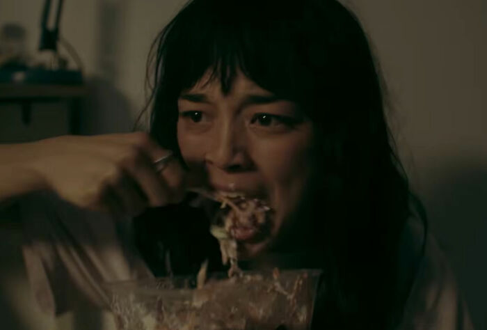A woman frantically eating from a bowl, a terrifying twist on the trend of being thinner than ever, from a new horror movie.