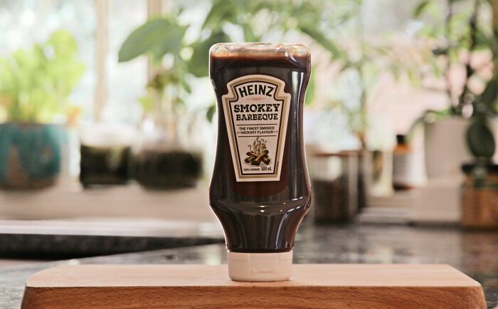 Bottle of Heinz Smokey Barbeque sauce on wooden board, an example of unusual items TSA has confiscated.