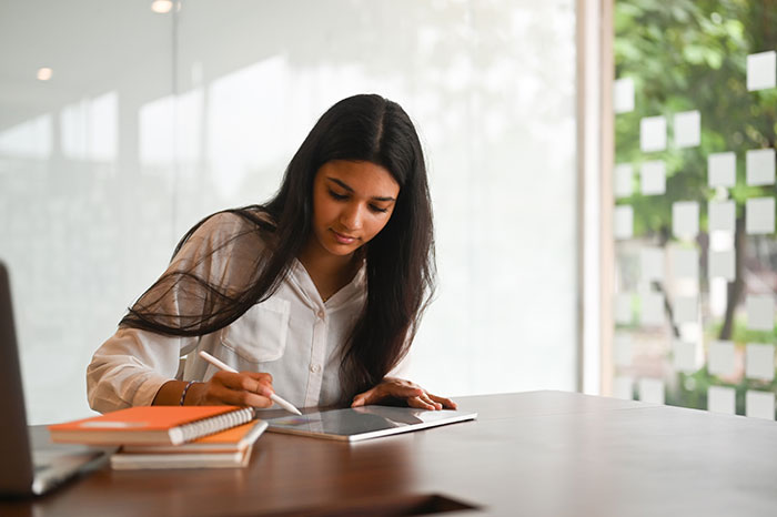 Teen girl using a tablet indoors, symbolizing a wealthy mom and house help family hypocrisy called out by teen.
