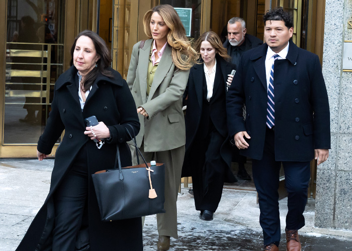 Blake Lively leaving courthouse with team, dressed in olive suit amid high-profile lawsuit attracting fan frenzy.