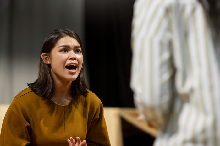 Young woman expresses anger while confronting another person, illustrating a tense scene in a book store manager school bully context. Young woman expresses anger while confronting another person, illustrating a tense scene in a book store manager school bully context.