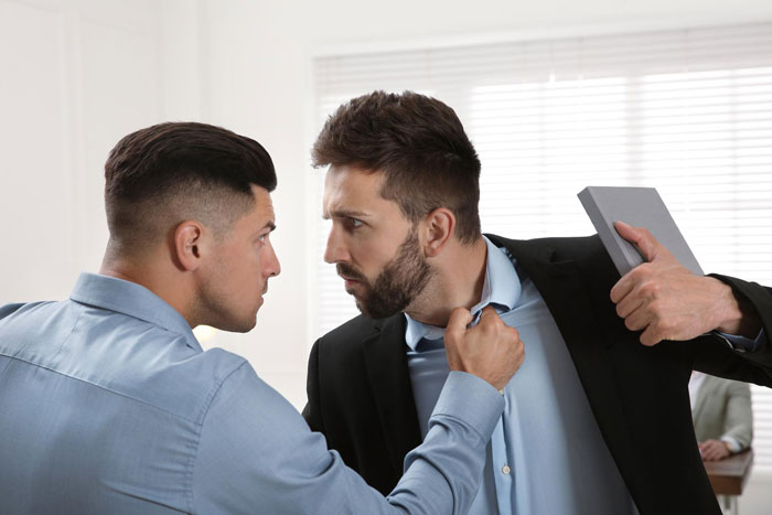 Two men in a heated argument, one gripping the other's shirt. This dramatic encounter could make a Dad an Uncle. Two men in a heated argument, one gripping the other's shirt. This dramatic encounter could make a Dad an Uncle.