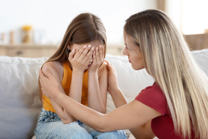 A crying daughter is comforted by her mother. The mother is supportive, unlike a heartless MIL.