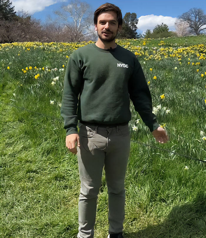 Handsome New York Botanical Garden scientist standing outdoors among daffodils on a sunny spring day. Handsome New York Botanical Garden scientist standing outdoors among daffodils on a sunny spring day.