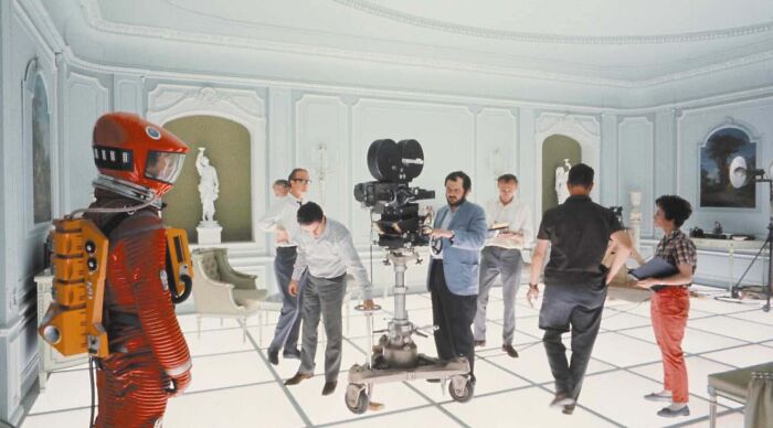 Guess the movie from BTS photos: The set of 2001: A Space Odyssey with cast and crew, including Stanley Kubrick.