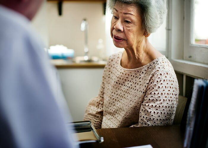 Elderly woman sharing a story that sounds made up but is 100 percent real during a heartfelt conversation.