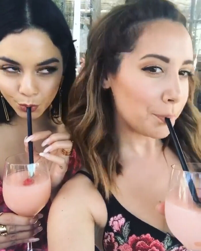 Two women sipping drinks close-up highlighting celebrity friendships