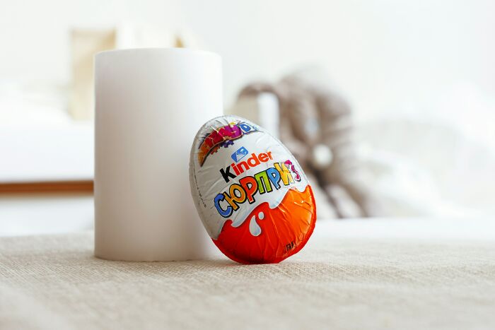 Foil-wrapped Kinder Surprise egg by a white candle. Some things medical workers witness, they wish they could unsee.