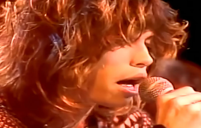 Close-up of a celebrity singing into a microphone, highlighting disturbing celebrity facts in an intimate performance setting.
