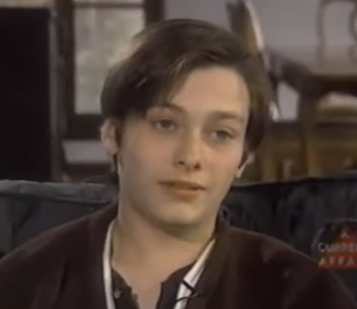 Young man in casual clothing sitting indoors, related to disturbing celebrity facts you might have never heard before