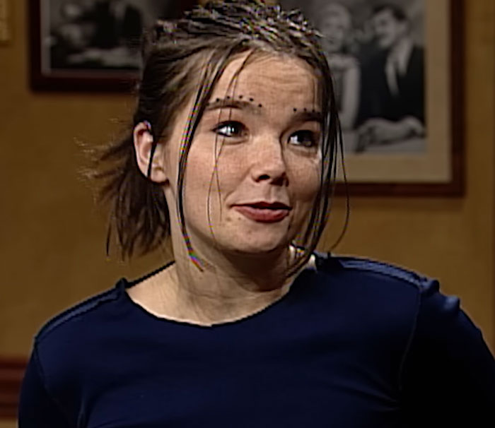 Young woman with braided hair wearing a dark blue shirt, shown in a candid moment related to disturbing celebrity facts.