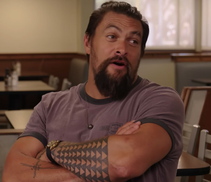 Man with tattooed arm and beard sitting in casual setting, related to disturbing celebrity facts discussion.