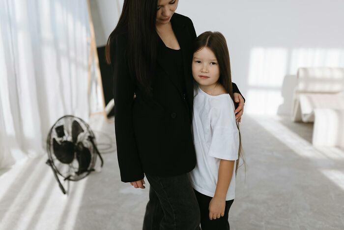 Mother and daughter in a softly lit room, illustrating the impact of horrible things parents have told their kids.