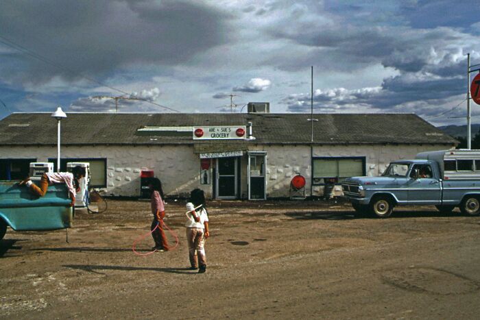 Children playing outside a run-down grocery store in one of the worst places in the US that people have visited.