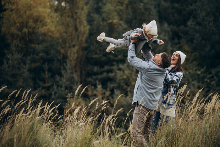 Happy family enjoying outdoors in autumn, capturing unexpected moments after DNA tests reveal surprising heritage.