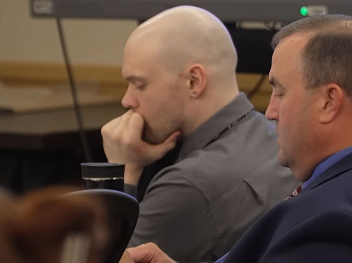 Two men in a courtroom setting, one deep in thought, highlighting Athena Strand&rsquo;s mom attending every court date.