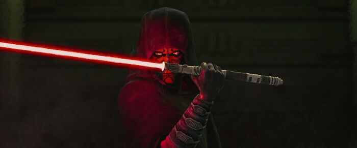 Star Wars Maul Shadow Lord character holding a red double-bladed lightsaber in a dark, ominous setting.