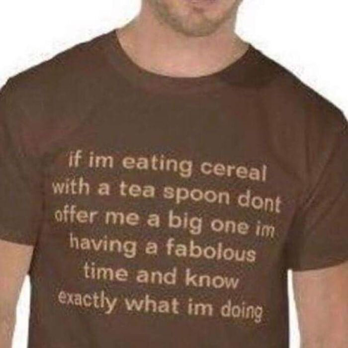 Man wearing a brown shirt with a funny meme about eating cereal with a teaspoon for a relaxing evening of humor.