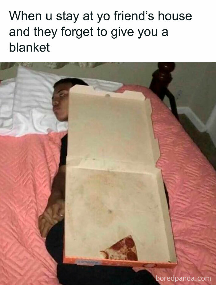 Person lying in bed with a pizza box covering their body, illustrating meme scrolling humor about missing a blanket.