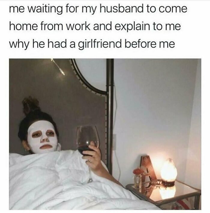 Person wearing a white facial mask in bed holding wine, humorously illustrating romantic relationships meme.