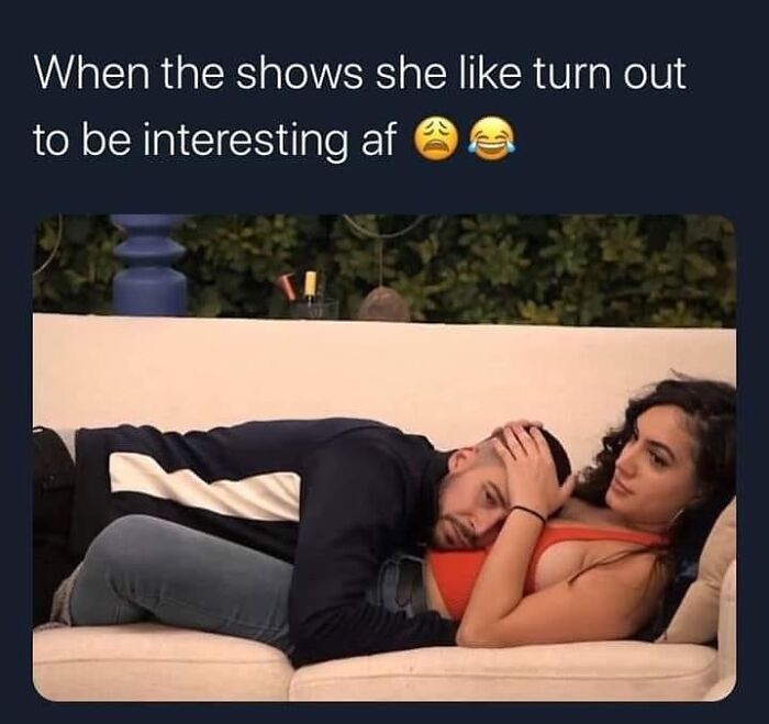 Couple relaxing on a couch with funny text illustrating relatable romantic relationships meme.