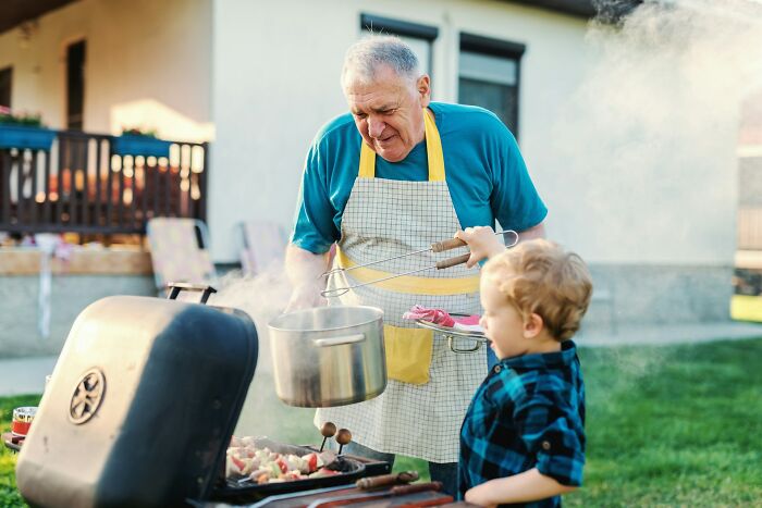 Older man and young boy grilling food together outside, sharing moments and tips parents just had to share with others.