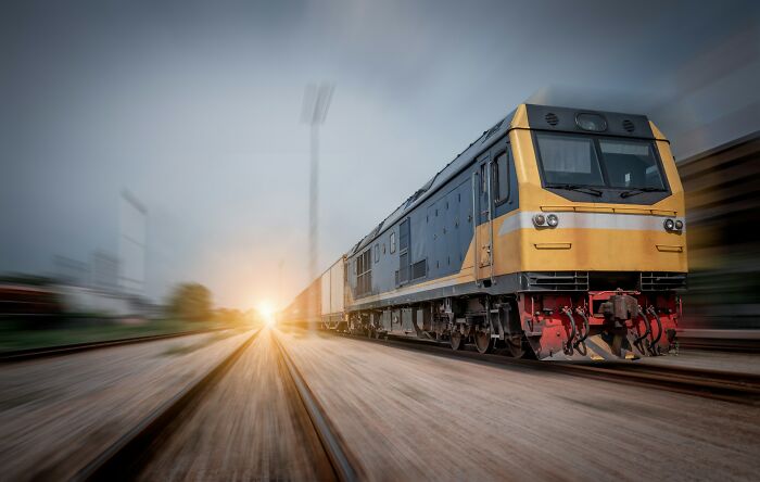 Fast-moving train on tracks at sunset, illustrating a moment linked to kids' lack of survival instincts.