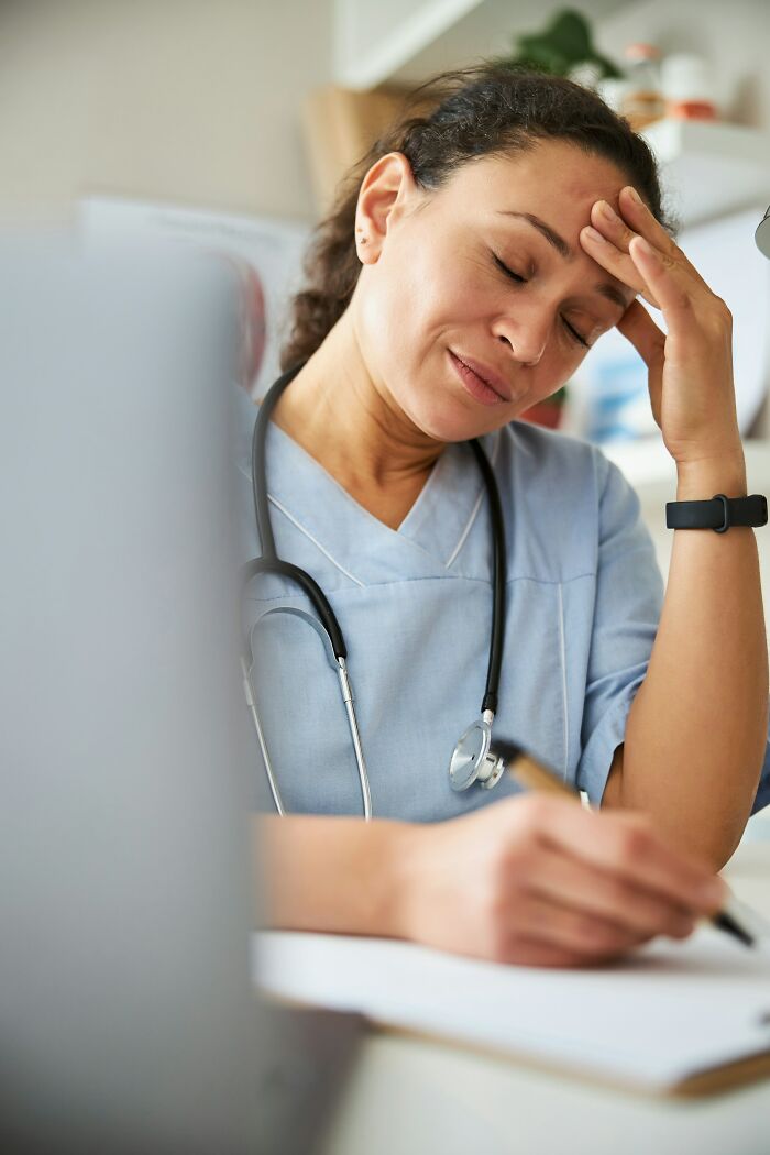 Tired healthcare employee with stethoscope showing stress, reflecting wild times employees quit their jobs immediately.