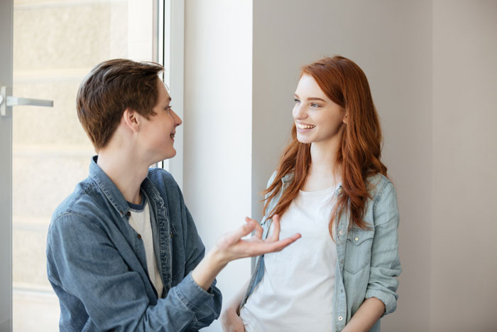 A young man with braces and a woman with red hair smiling at each other, discussing their friendship. #affair