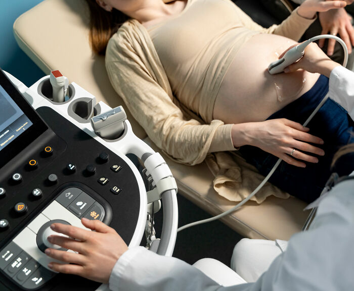 Pregnant doctor performing ultrasound showing baby peeing inside the womb in a viral medical video session.