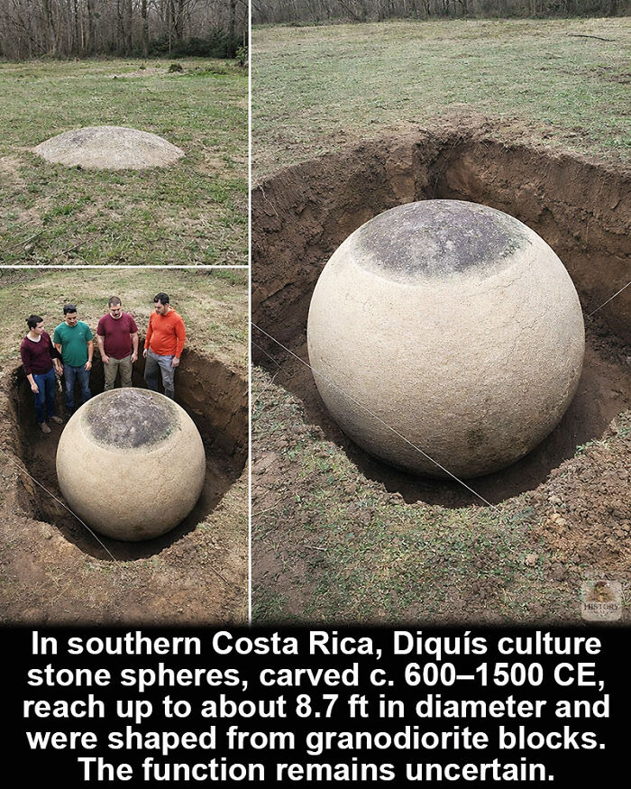 Large historical marvel stone sphere from Diquís culture partially buried in soil with people standing nearby for scale.