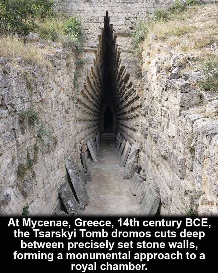 Tsarskyi Tomb dromos at Mycenae Greece, a historical marvel with deep stone walls leading to a royal chamber.