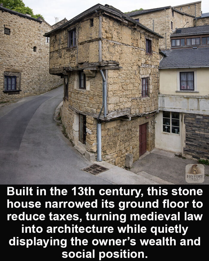 Stone house built in the 13th century narrowing its ground floor, a historical marvel surviving through time with medieval architecture.