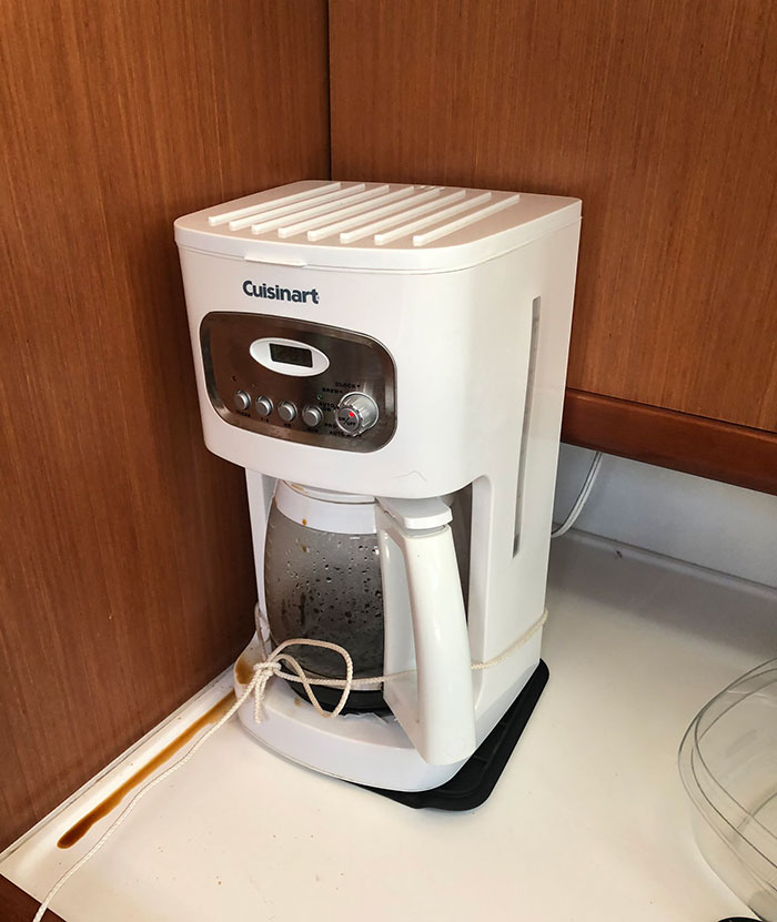 Coffee maker tied to countertop in a hotel room kitchen, showing tips for a more elevated and stress-free stay.
