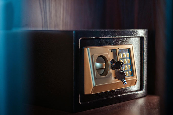 Hotel room safe with keys inserted, illustrating tips for a more elevated and stress-free hotel stay.