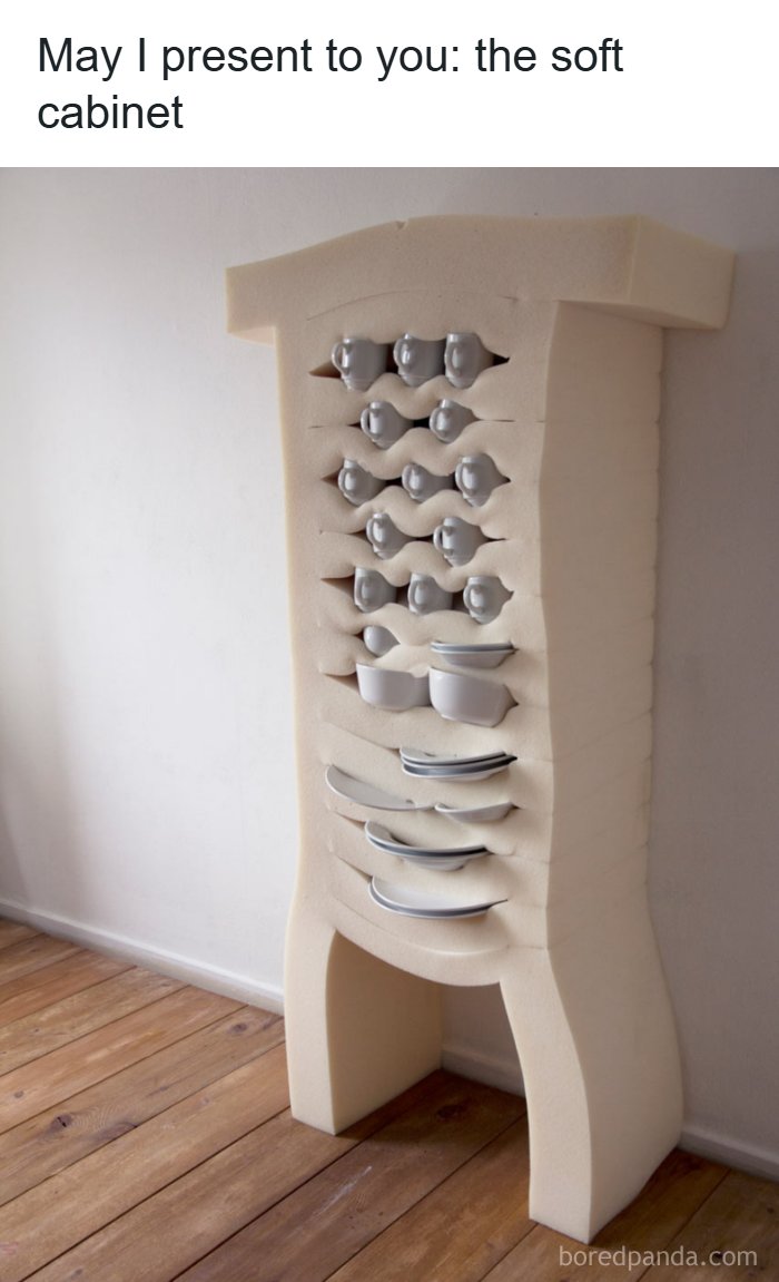 Unhinged soft cabinet with cups and plates embedded in a flexible, cushion-like frame against a plain wall.
