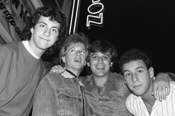 Black and white photo of four young men close together depicting celebrity friendships