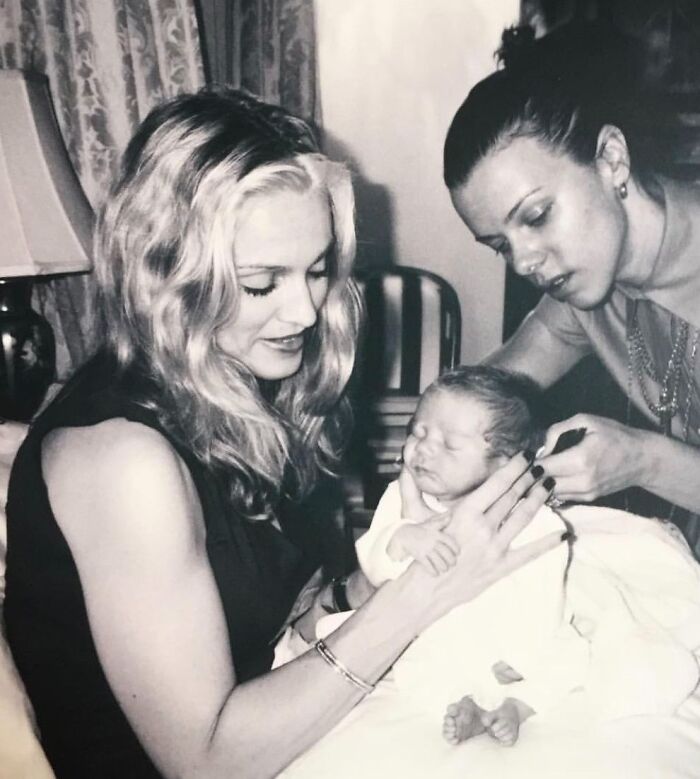 Black and white photo of two women and newborn showing celebrity friendships