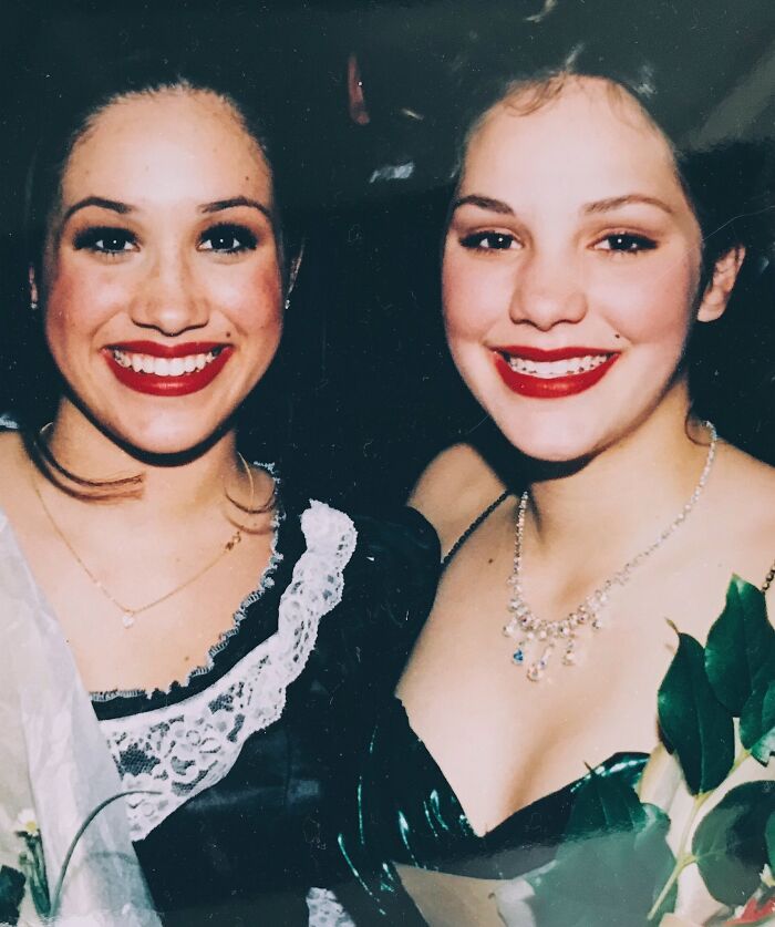 Two smiling women dressed up sitting close up in celebrity friendships