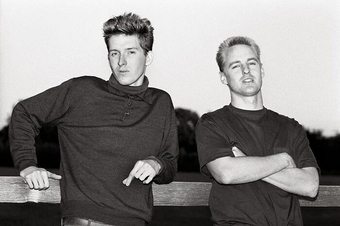 Black and white photo of two young men posing outdoors showing celebrity friendships