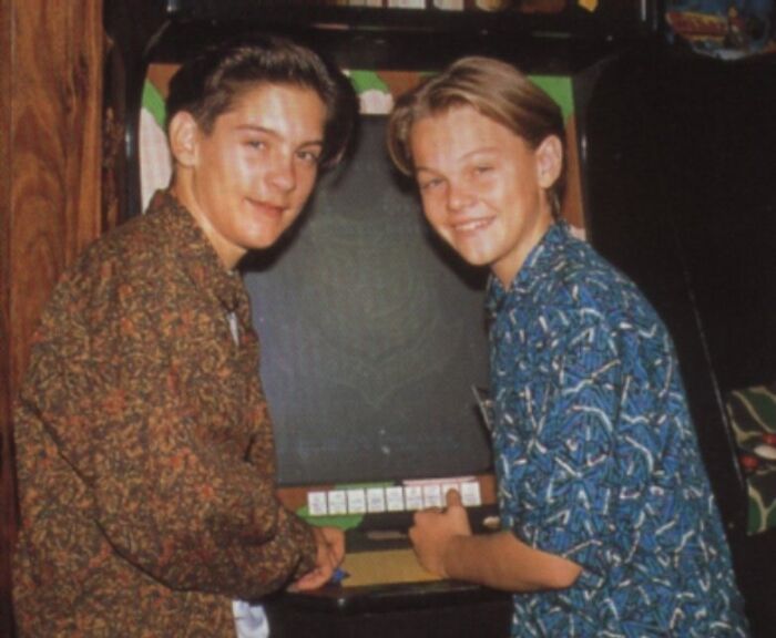 Two young men playing arcade game showing celebrity friendships