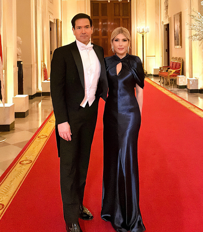 Couple in formal wear on a red carpet, one of the worst MAGA looks during King Charles' White House visit.