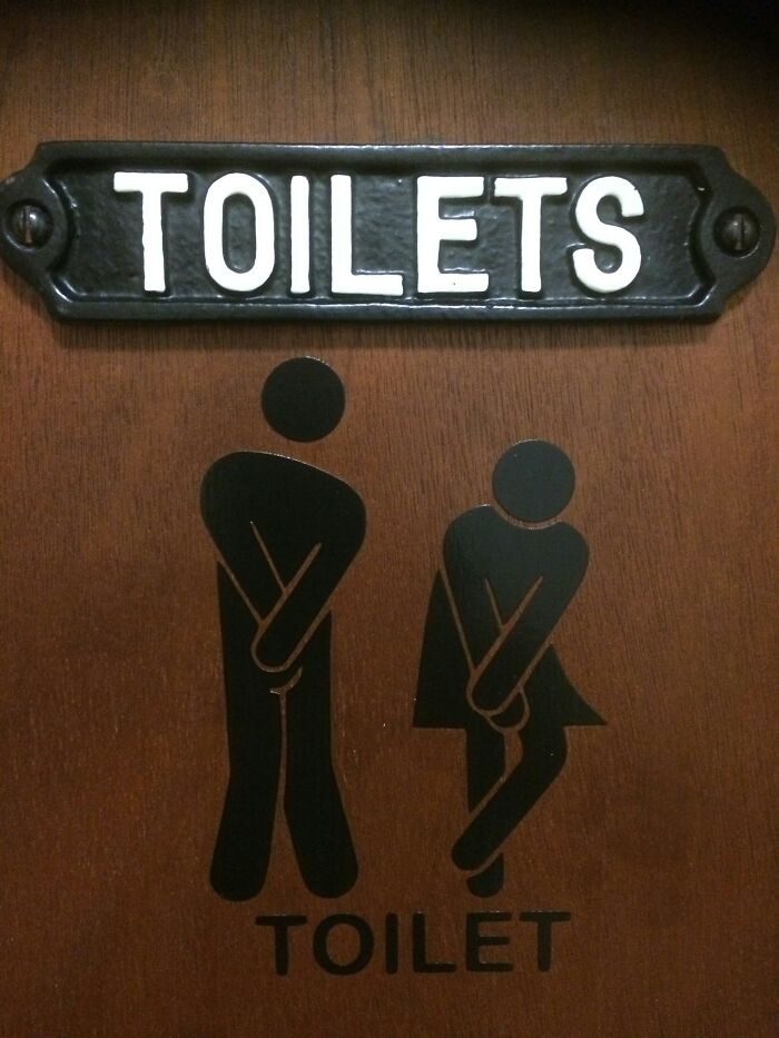 Funny toilet sign with male and female figures urgently needing to use the restroom, relatable to those who rage quit their jobs.