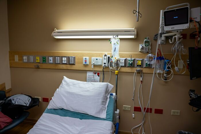 Empty hospital bed with medical equipment and monitors in a room symbolizing unexpected and bizarre ways people passed away.