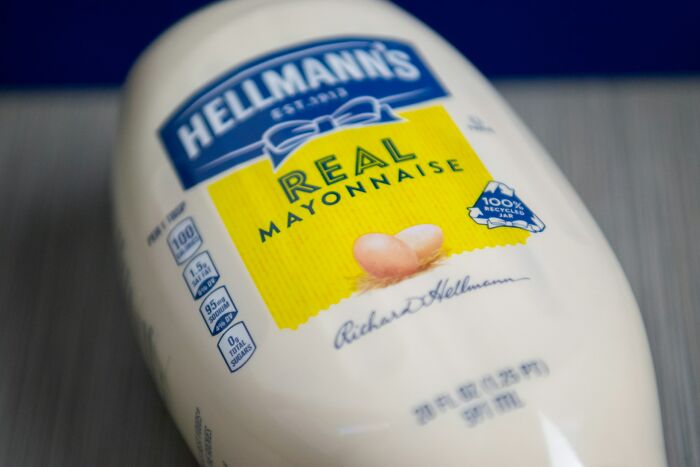 Bottle of Hellmann’s Real Mayonnaise on a table, highlighting common family food items that seem bizarre now.